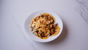 QR Menu Handmade Turkish dumplings topped with yogurt, garlic, and spicy butter sauce.